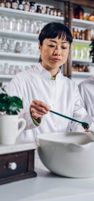 Apothecary workers are working on a drug and packing the tea in