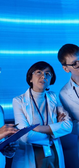 forward-thinking multiethnic scientists with clipboards collabor