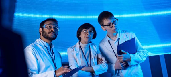 forward-thinking multiethnic scientists with clipboards collabor